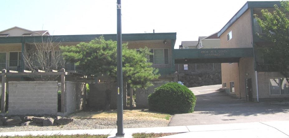 a building with an overpass and a sidewalk